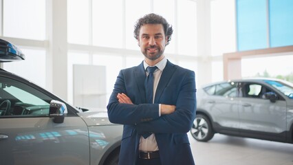 Zooming in on attractive Caucasian businessman or manager. Man wearing elegant blue suit while...