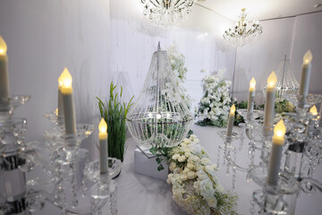 The wedding ceremony. Luxurious decor with flowers in the restaurant.