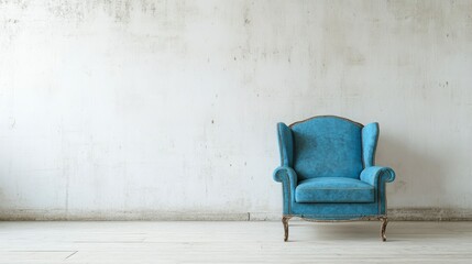Blue wingback armchair against a white textured wall in a minimalist room.