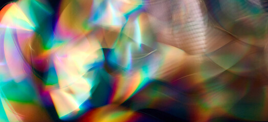Blurred bright rainbow light. Lens or prism dynamic flare. Draving shiny spots. Dark background....
