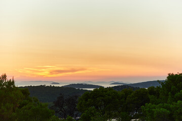 Breathtaking sunset over the archipelago, painting the sky with warm colors of orange, pink, and purple