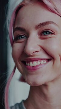 Young woman with pink hair and striking blue eyes expresses emotion through her gaze