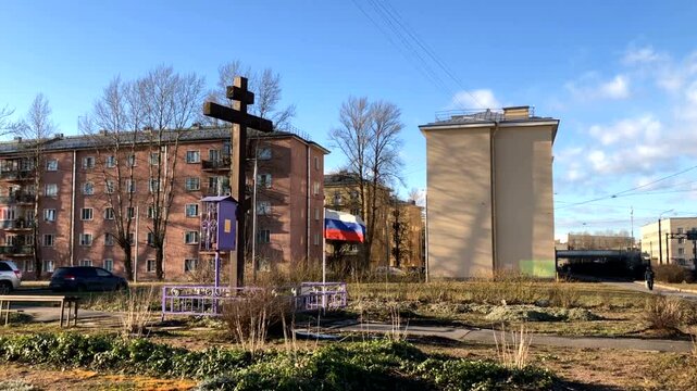 cross and flag on the grave, monument to the dead
