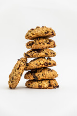a stack of homemade oatmeal raisin cookies on a white background. Cozy and simple composition of traditional snack. bakery style poster.