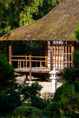 Fototapeta premium Tea pavilion by a small lake in spring in the Japanese garden Pierre-Baudis within the Compans-Caffarelli garden in Toulouse