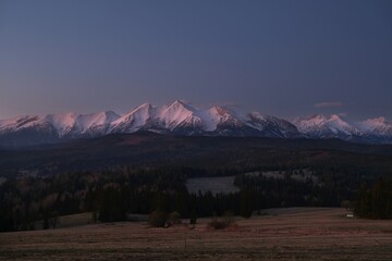 The snow-capped peaks of the High Tatras mountains in sunrise light from viewpoint Pass over...