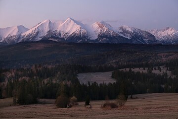 The snow-capped peaks of the High Tatras mountains in sunrise light from viewpoint Pass over...
