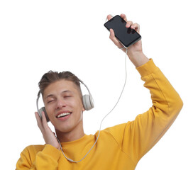 Happy man in headphones dancing with smartphone on white background