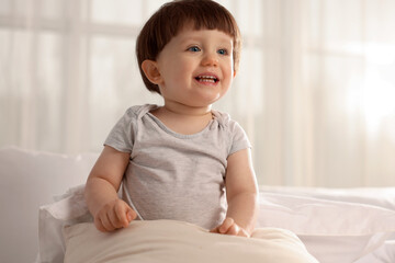 Fototapeta premium Cute little boy in bed at home, space for text