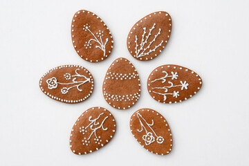 Romantic decorated Easter gingerbread cookies in a shape of egg, white background