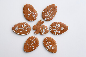 Romantic decorated Easter gingerbread cookies in a shape of egg and bunny, white background