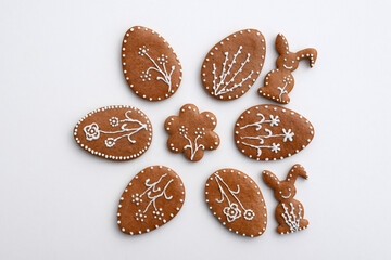 Romantic decorated Easter gingerbread cookies in a shape of egg, bunny and flower, white background