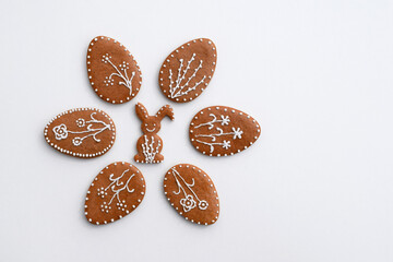 Romantic decorated Easter gingerbread cookies in a shape of egg and bunny, white background, copy space for text