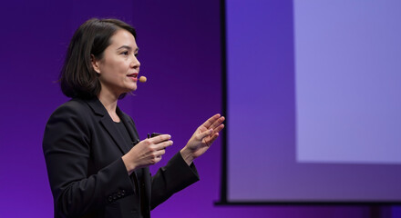 Caucasian businesswoman giving presentation on stage. Professional female speaker at conference with projection screen. Leadership and public speaking. banner for business events, corporate training