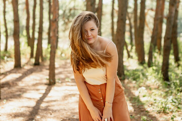 Obraz premium beautiful young woman walks in the woods in the summer, meditates