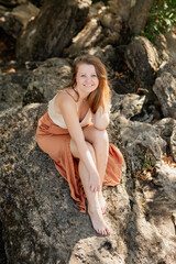 beautiful young woman walks in the woods in the summer, meditates