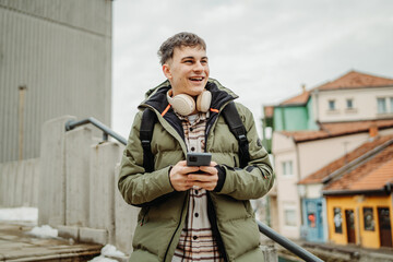 Young adult caucasian man student smile and use phone to take self portrait or video call
