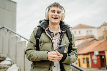 Young adult caucasian man student smile and use phone to take self portrait or video call