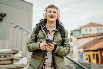 Young adult caucasian man student smile and use phone to take self portrait or video call
