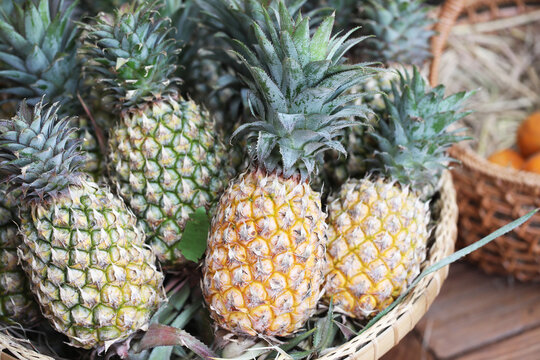 Pineapple or Ananus fruit in traditional Asian basket