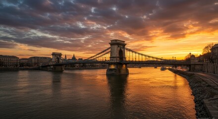 Fototapeta premium Budapest Chain Bridge Sunset Panorama - Majestic Chain Bridge at sunset, connecting Buda and Pest across the Danube, symbolizing connection, history, beauty, cityscape, and Hungarian heritage