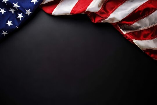 American flag draped on a dark surface creating a patriotic background with and stripes display