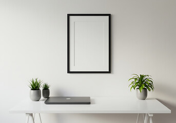 Black frame mockup on white wall with laptop and plants for decoration