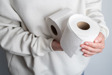 Woman's hands holding soft white toilet paper roll. Hygiene concept. Close-up