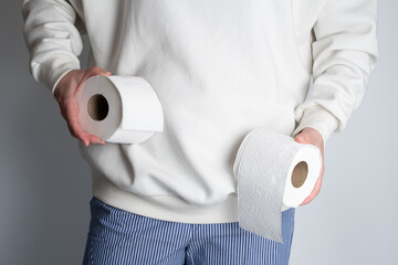 Woman's hands holding soft white toilet paper roll. Hygiene concept. Close-up