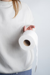 Woman's hands holding soft white toilet paper roll. Hygiene concept. Close-up