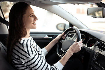 Driver behind steering wheel of modern car