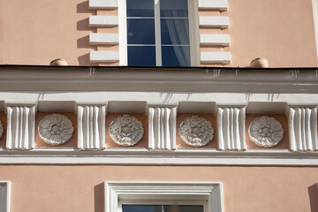 Elegant Neoclassical Building Facade with Ornamental Reliefs in Vilnius, Lithuania