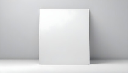 Naklejka premium A large, blank white canvas leans against a gray wall, perfect for any design idea or art.