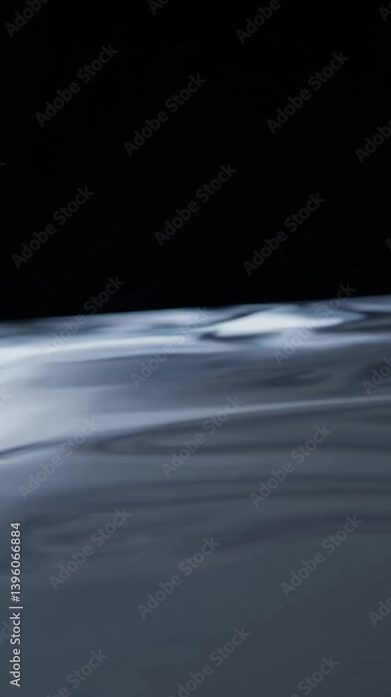 Poster dark liquid surface gliding smoothly, reflecting soft light and generating mesmerizing rippling patt
