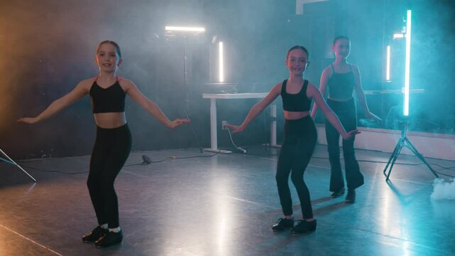 Young girls in a stylish studio doing a tap dance routine