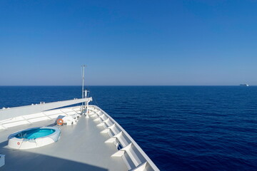 The bow of a cruise liner plows through the ocean.