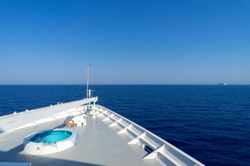 The bow of a cruise liner plows through the ocean.