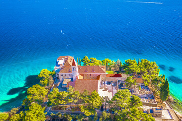 A breathtaking aerial photograph of the Dominican Monastery in Bol on Brac Island, Croatia, nestled...