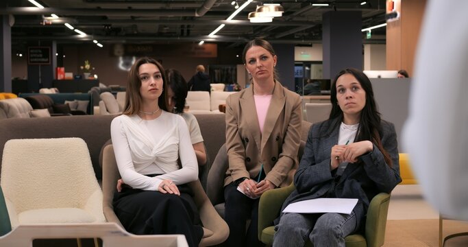 Job applicant gesturing while communicating with recruiters during interview, highlighting professional nonverbal interaction in modern corporate environment. concept of woman is collection