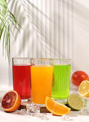 Modern still life with citrus fruits. Orange juice, thick smoothie and oranges, grapefruit, lime,...