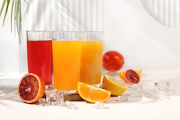 Modern still life with citrus fruits. Orange juice, thick smoothie and oranges, grapefruit, lime, blood orange and lemon on elegant kitchen table. Detox diet and weight loss concept, summer drinks,