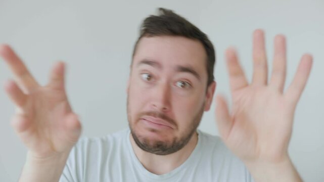 Young man making a dramatic and exaggerated expression with raised hands