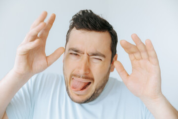 Man shows exaggerated expression of disgust during a playful moment at home