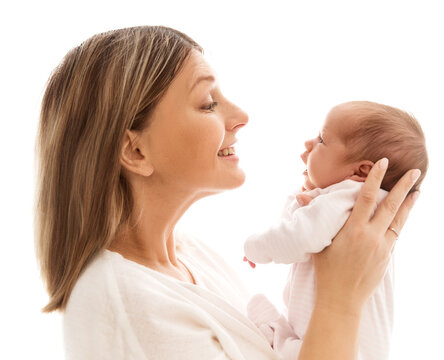 Happy Mother looking at Baby. Smiling Mom holding Newborn in Hand side view over white background. Childbirth and Child Health Care. Mother's day. Mother Love Baby