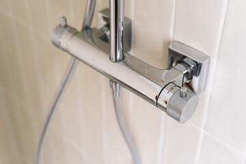 Modern shower cabin faucet in stylish apartment bathroom interior design