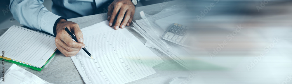 Poster business person calculating invoices using calculator in office