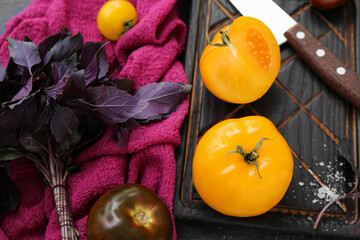 Board with different fresh tomatoes, closeup
