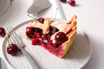 Plate with piece of tasty cherry pie on white background