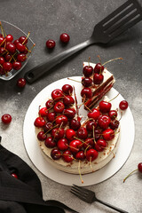Tasty cherry cake on grunge background