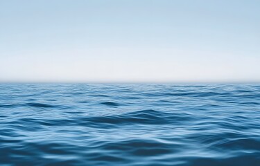 Calm blue ocean stretching to the horizon under a clear sky, capturing the vastness and tranquility of the sea in a serene, minimalist composition